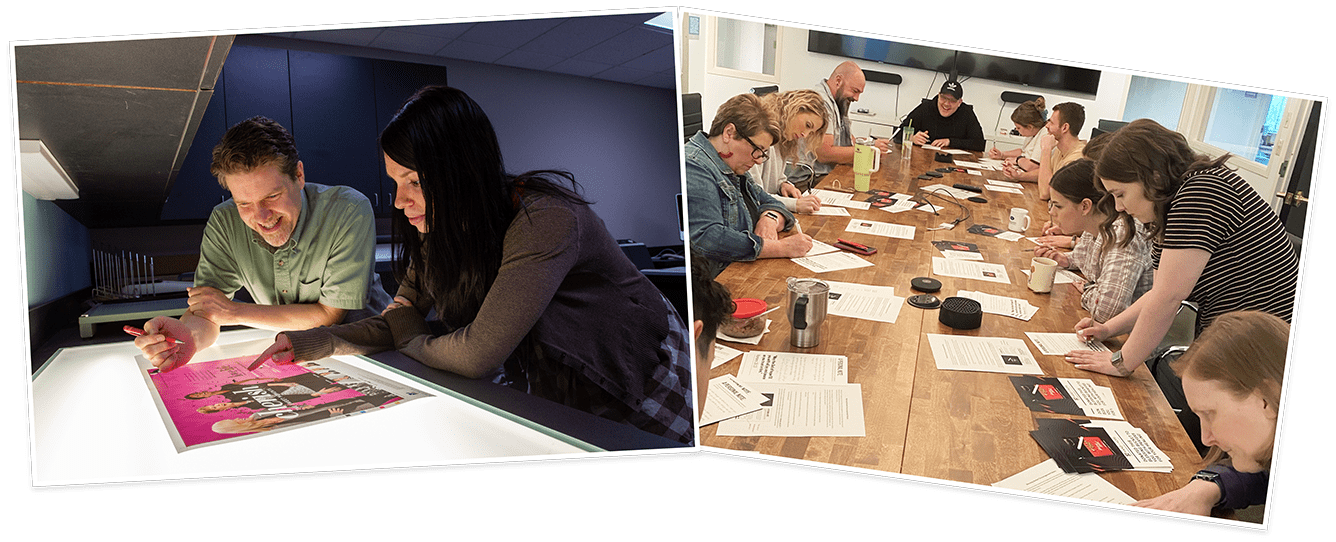 People examining a photo and team working at a large table