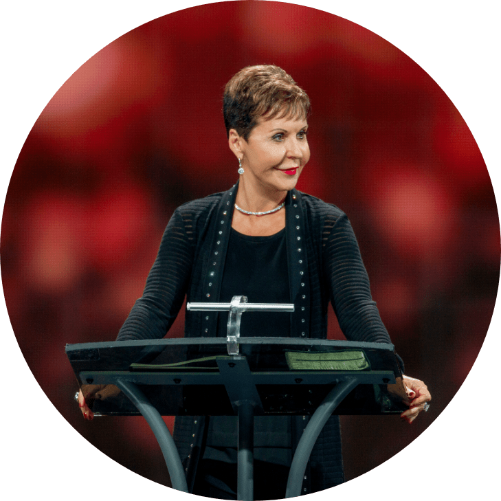 Joyce Meyer at a conference teaching behind a podium.